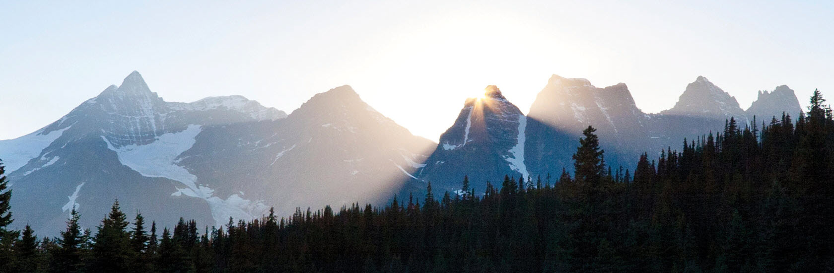 Sun rising over a mountain range
