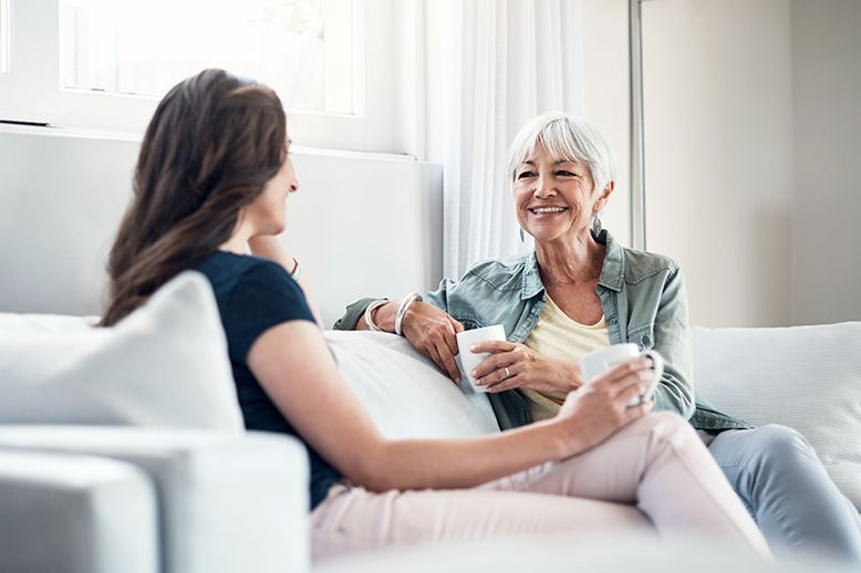 adult daughter talking to senior mother