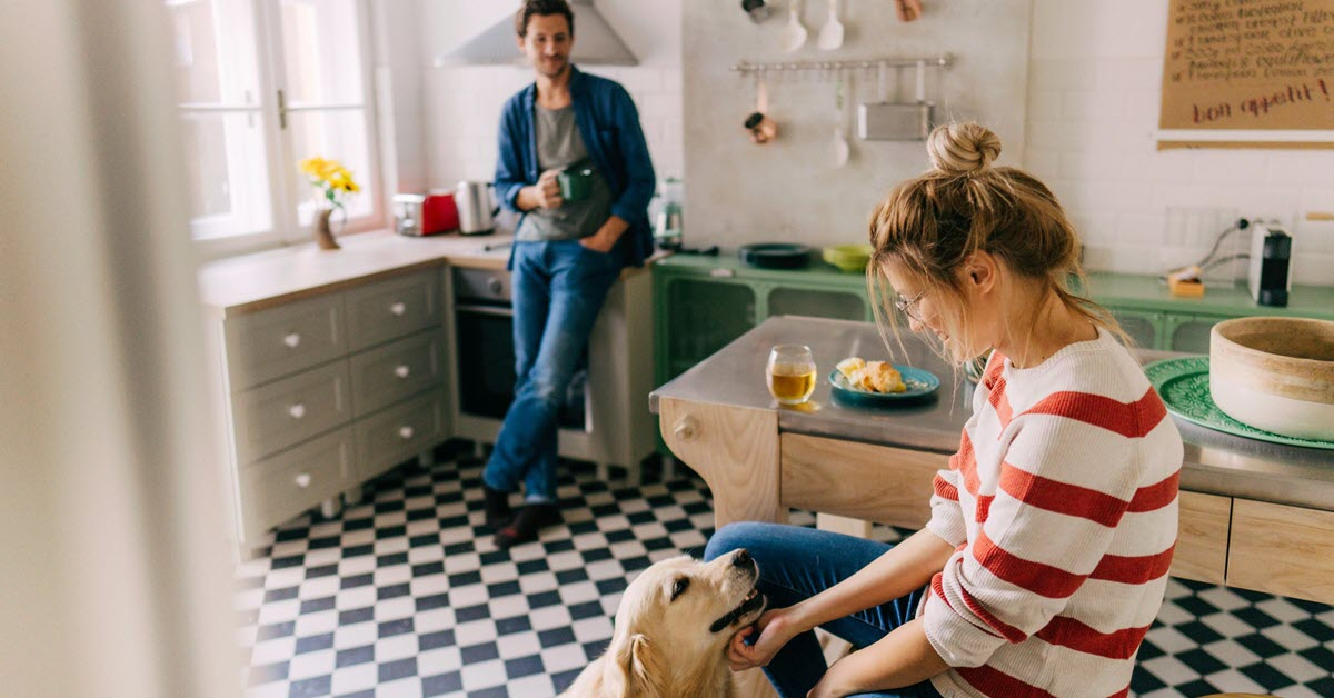 Couple in kitchen with dog