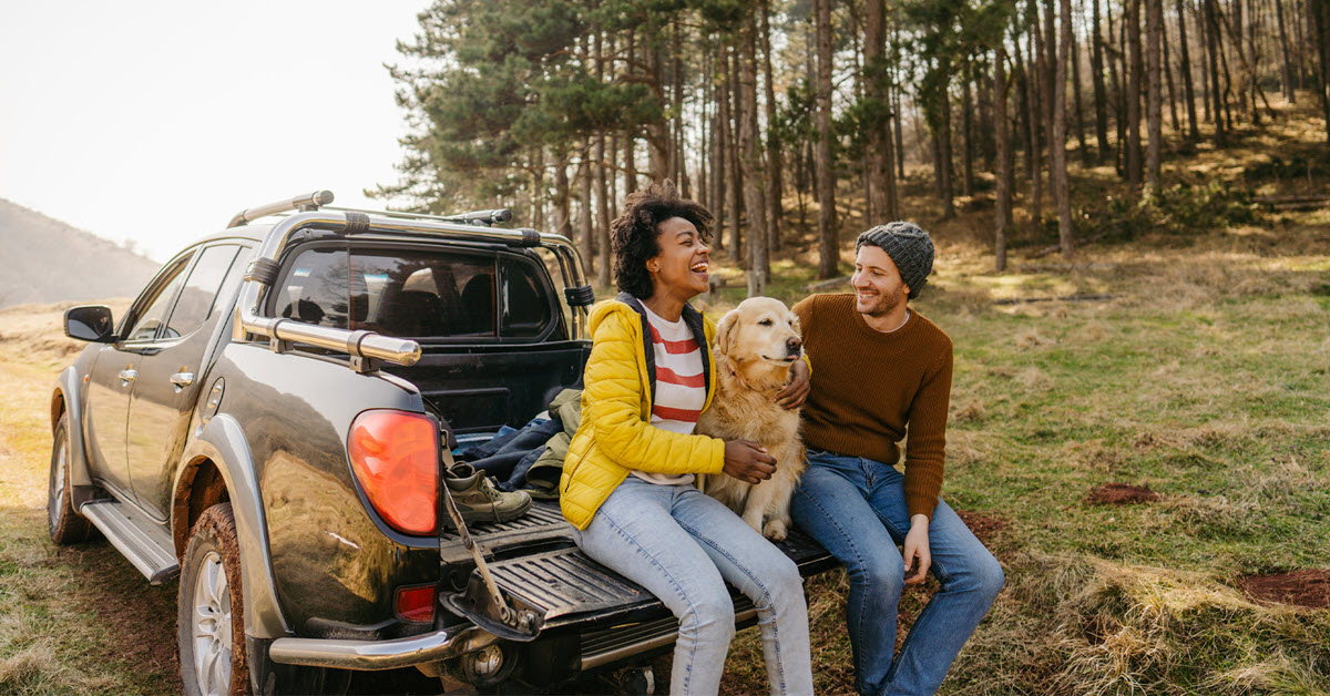 Couple with dog on a road trip