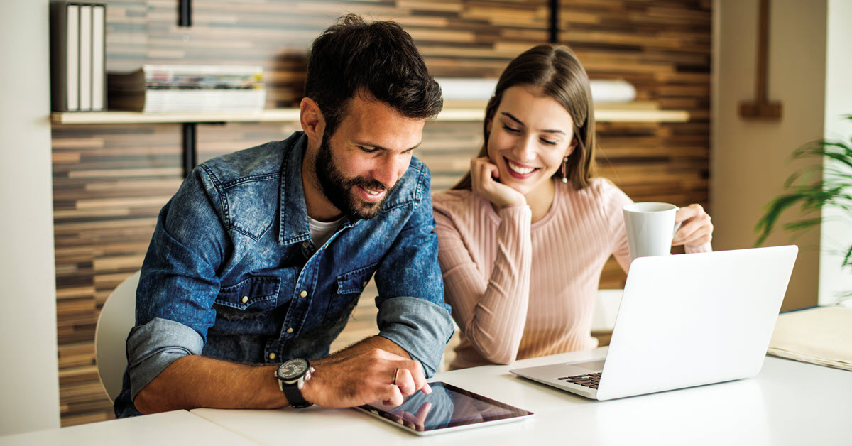 Man and woman reviewing information on a computer.