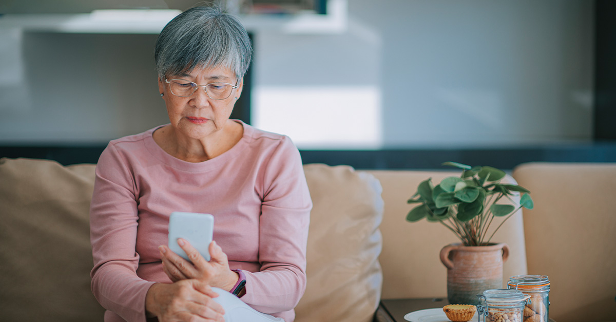 Elderly woman looking at her smartphone