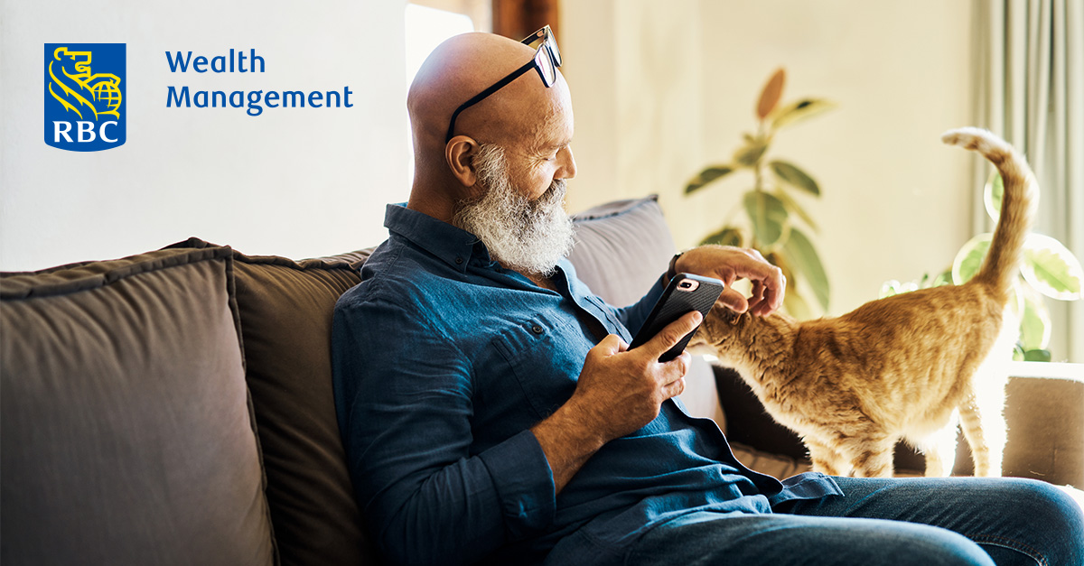 Senior man with a cat holding a smart phone
