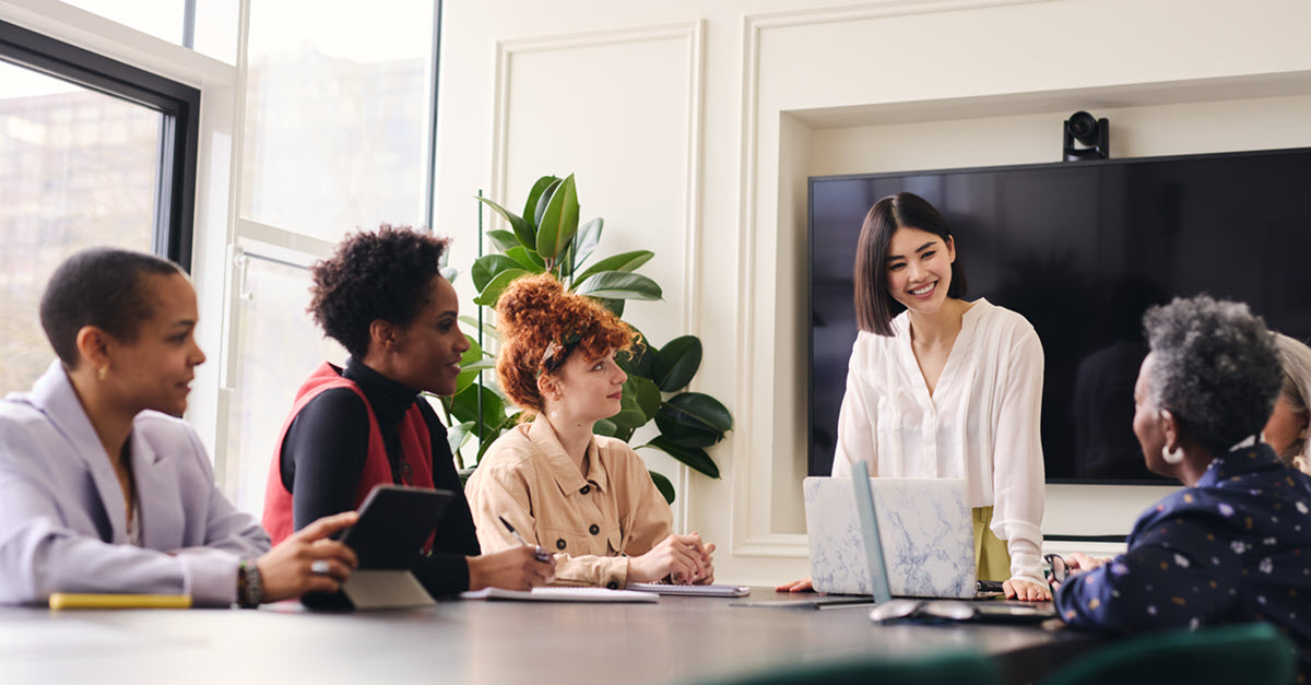 Employees in conference room around a table