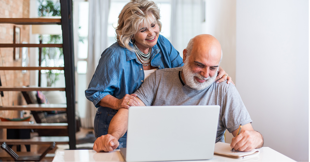 Senior couple looking at a laptop together