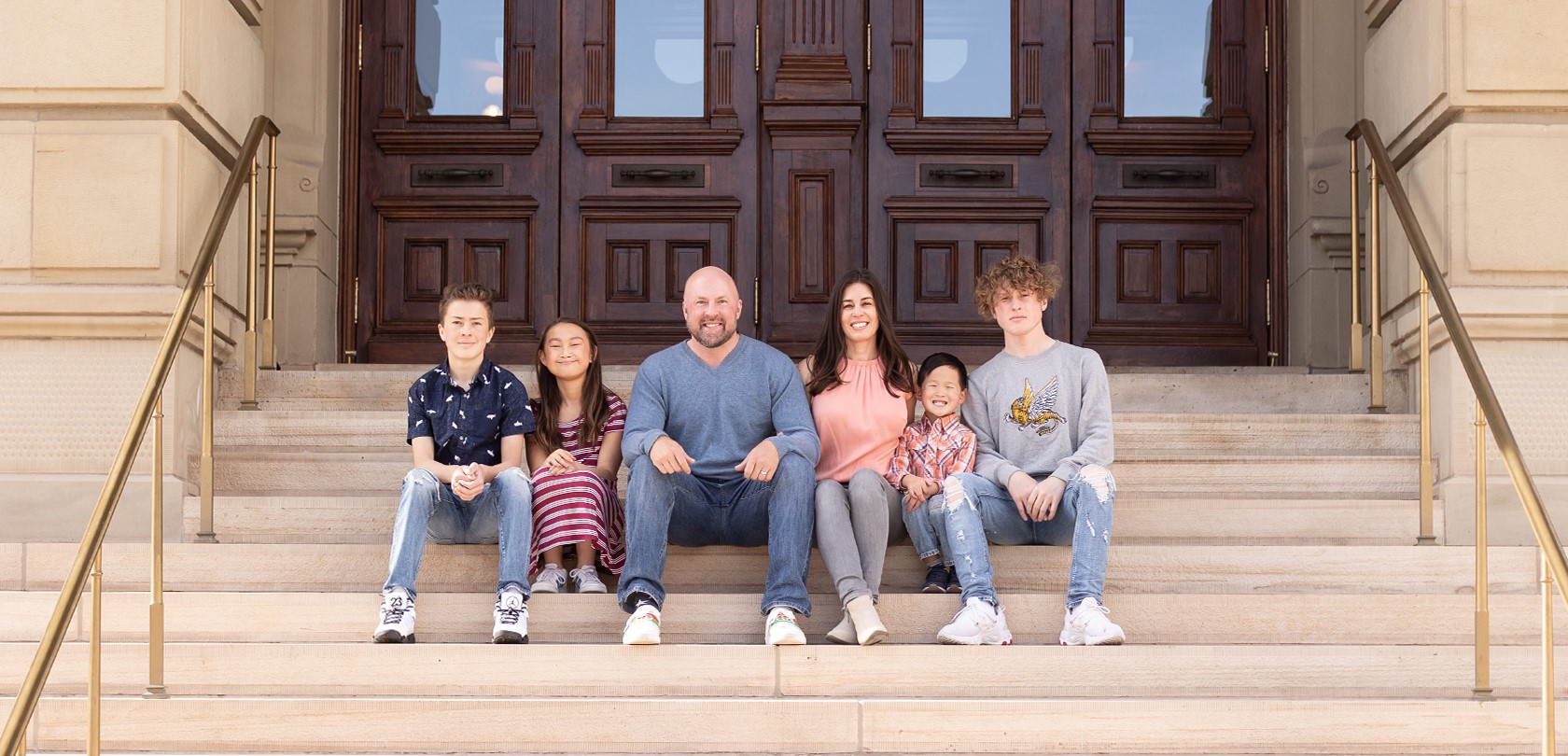 Pedersen family seated on stone stairs