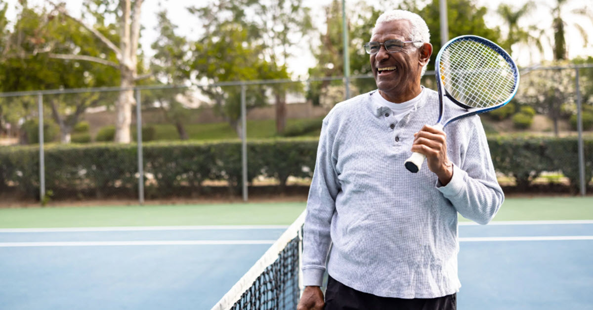 Retired man playing tennis