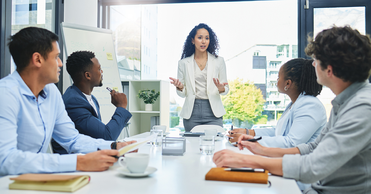 Woman speaking to colleagues during a meeting