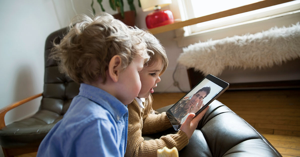 kids looking at mobile device