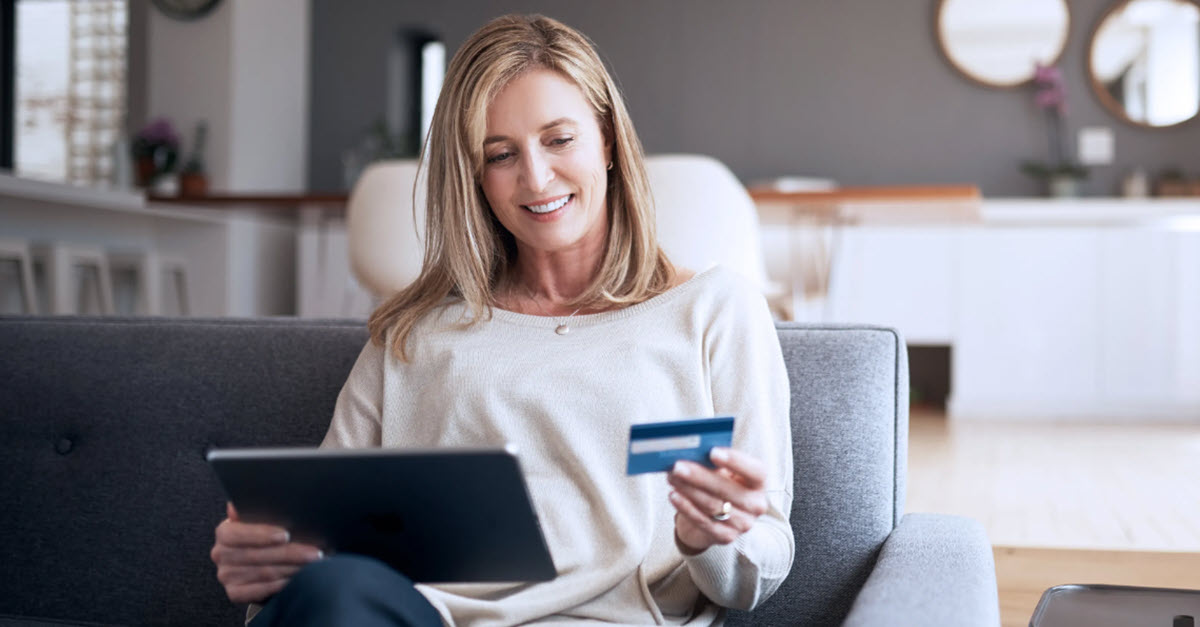 Woman entering her credit card number into her laptop
