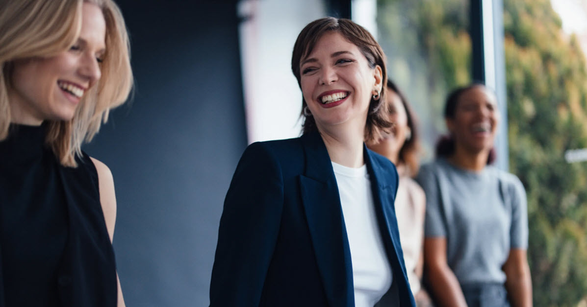 Younger business women walking together and laughing