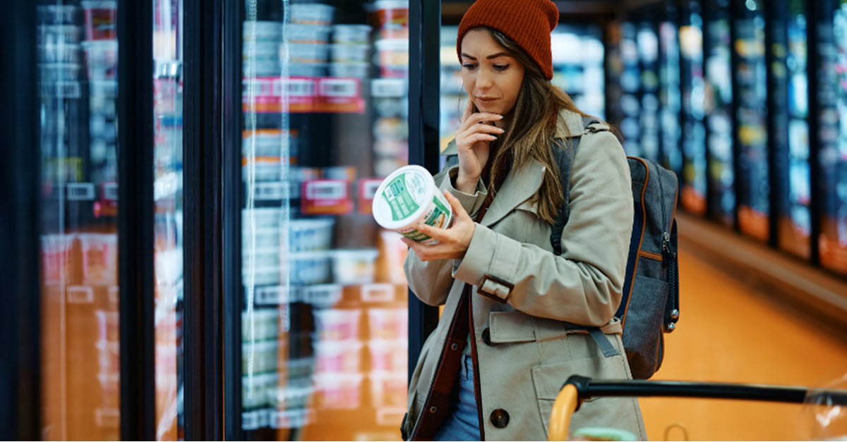 Woman in grocery looking at prices