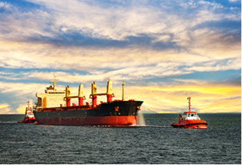 Tug boat pulling cargo ship