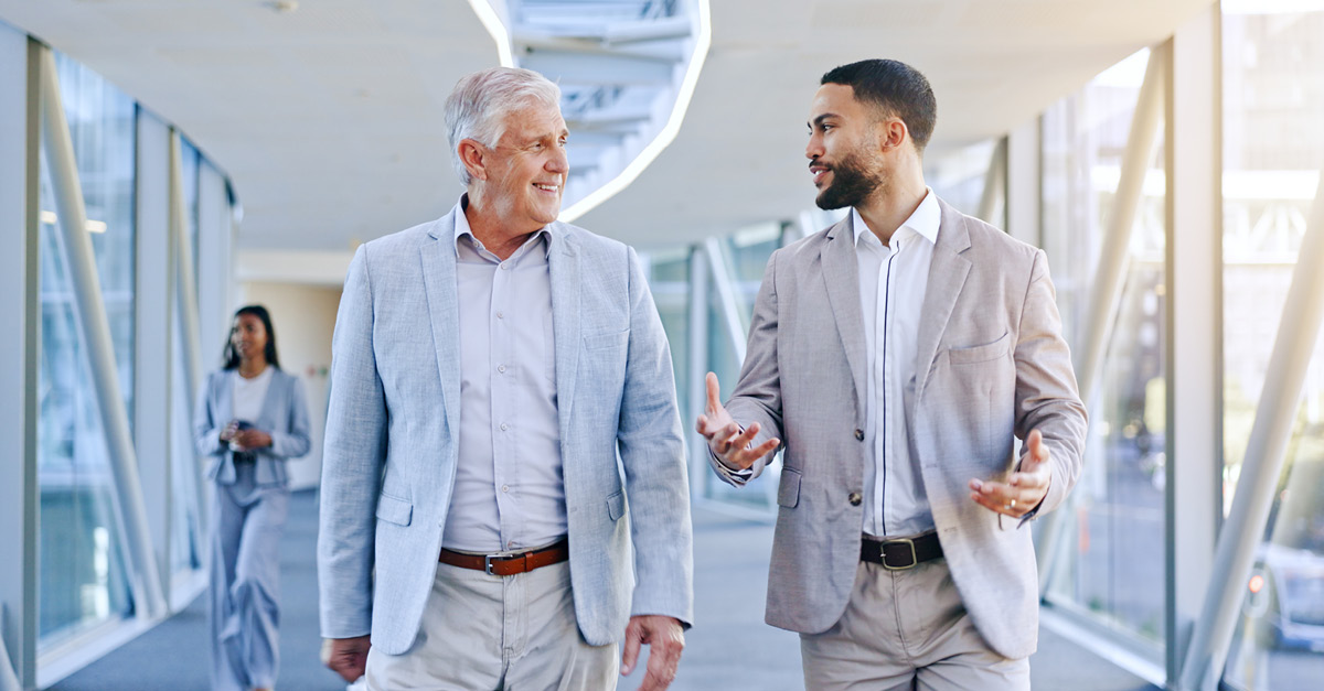 Mature entrepreneur walking and talking to advisor