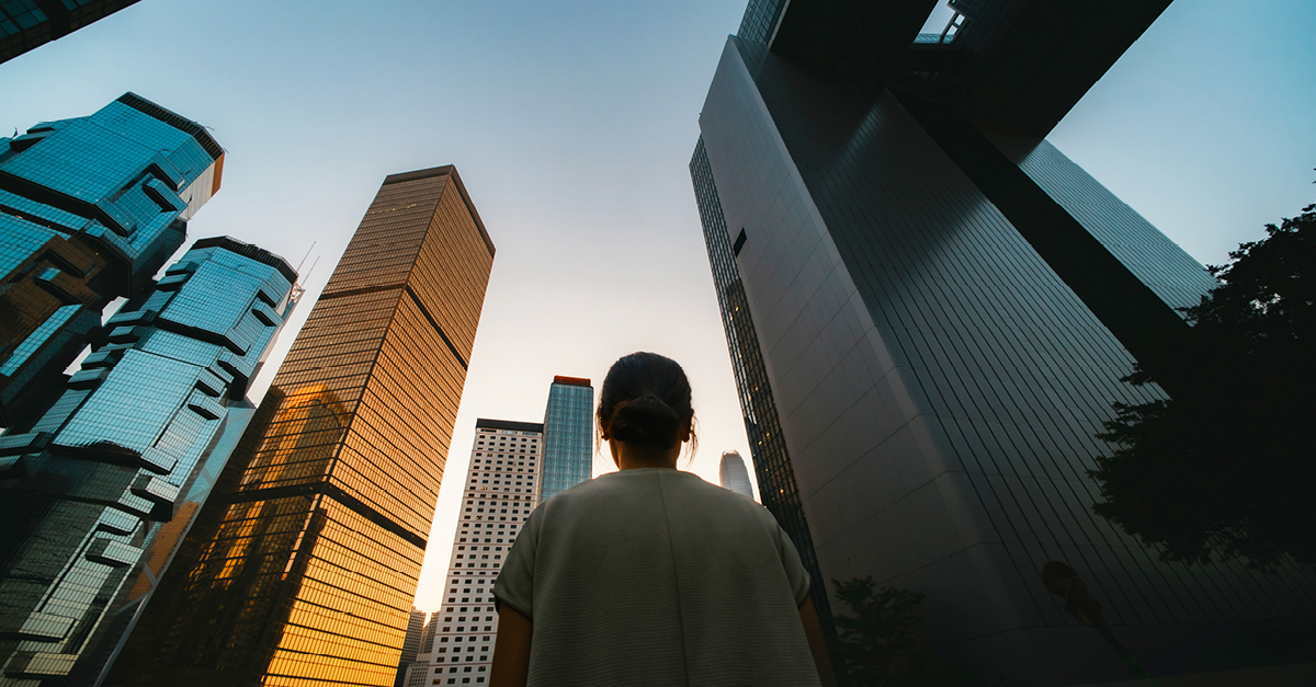 Woman walking among skyscrapers
