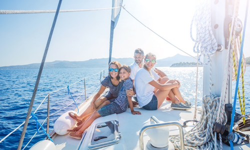 family with kids resting on yacht adventure travel