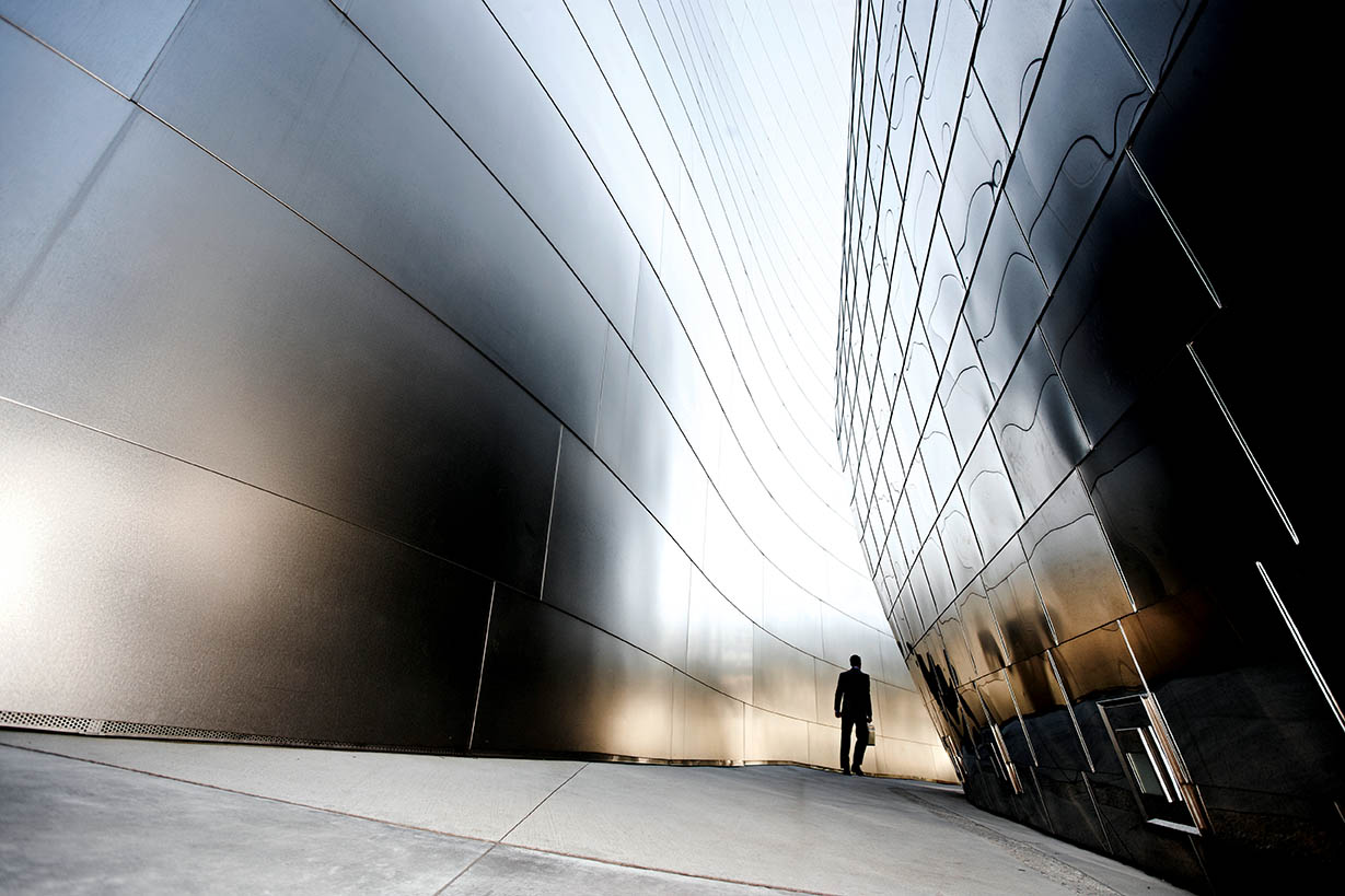 Architecture image with man walking between buildings