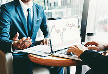 Two people monitoring charts