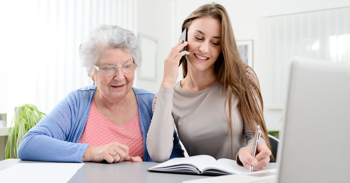 Daughter and mother reviewing finances