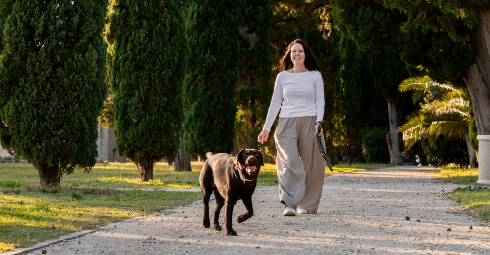 Woman walking her dog on a sunny day