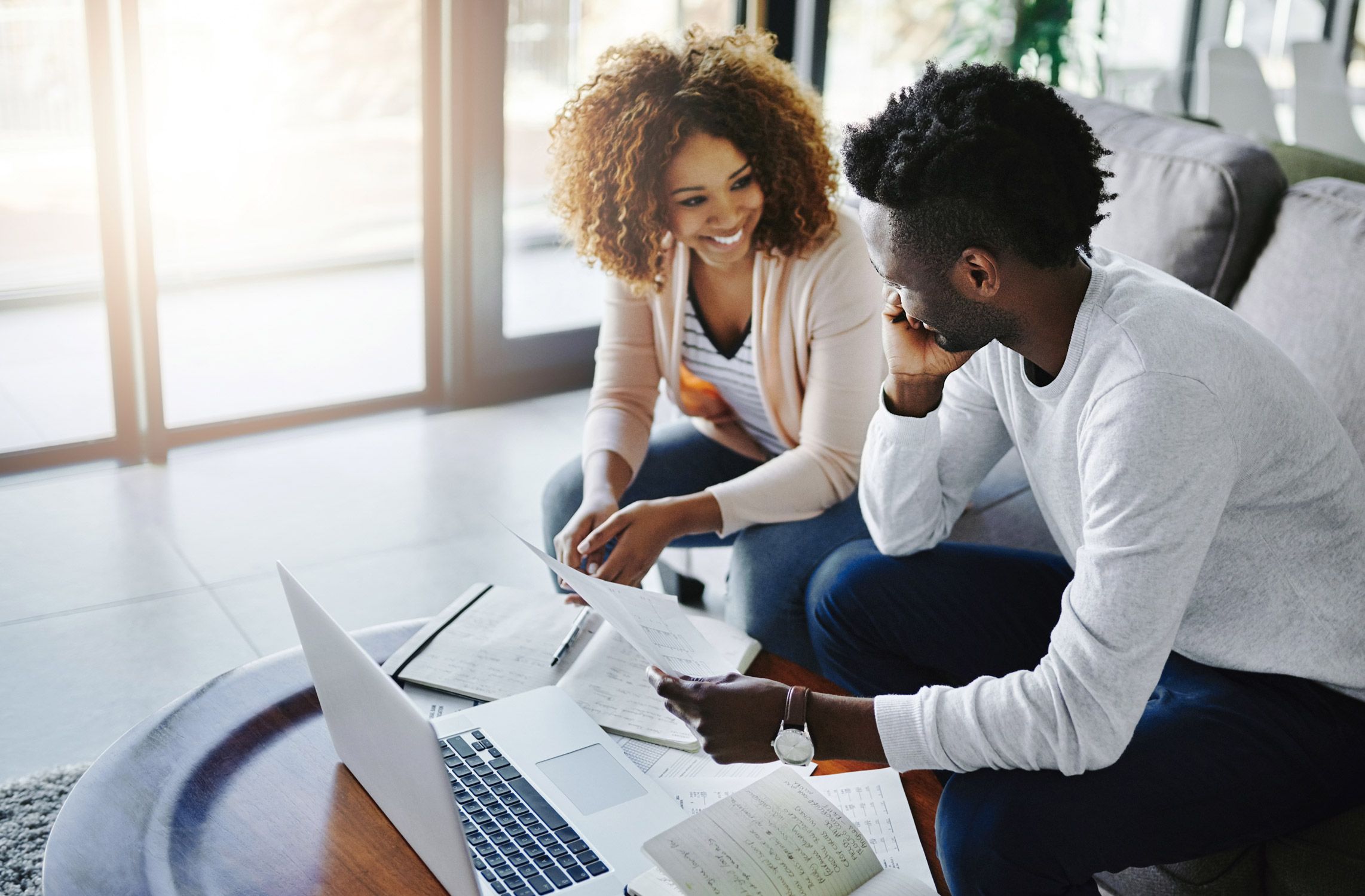 smiling couple reviewing finances